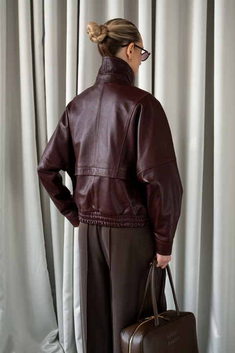 Chic woman in premium leather outerwear and minimalist accessories, highlighting MULVANNI’s elevated everyday style.