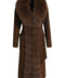 A brown coat expertly tailored from 100% double-faced cashmere, featuring clean lines, a matching belt at the waist, and a luxurious brown fox fur trim cascading along the front.