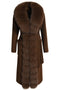 A brown coat expertly tailored from 100% double-faced cashmere, featuring clean lines, a matching belt at the waist, and a luxurious brown fox fur trim cascading along the front.