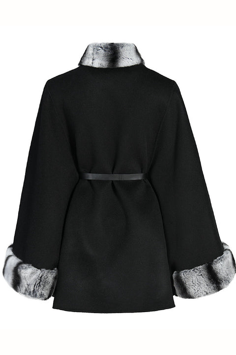 Timeless plus-size cashmere cape designed to enhance fuller figures, complete with a rex rabbit fur collar and adjustable leather belt.