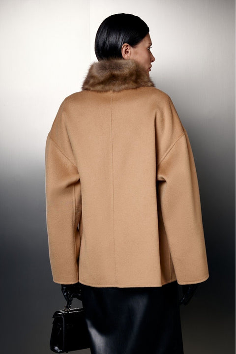 Back view of a woman wearing a Short Camel Wool Coat with Mink Fur, showcasing its luxurious design and warmth.