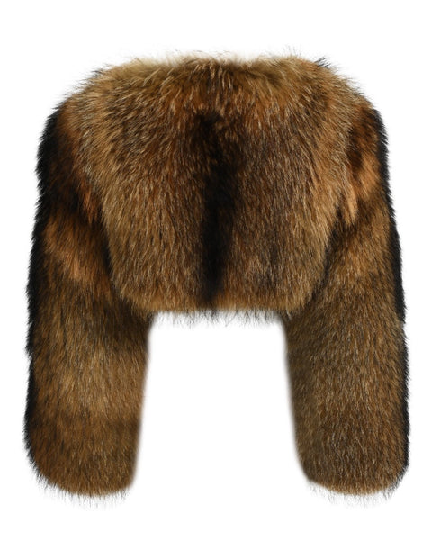 A fashionable cropped raccoon fur coat featuring long sleeves. The rich, multi-toned fur creates a striking contrast, adding flair and sophistication to the woman’s winter attire.